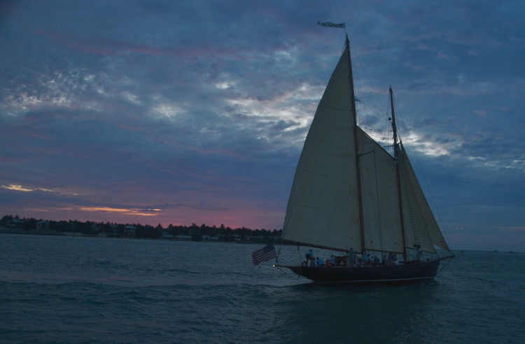 sailboat on water at sunset